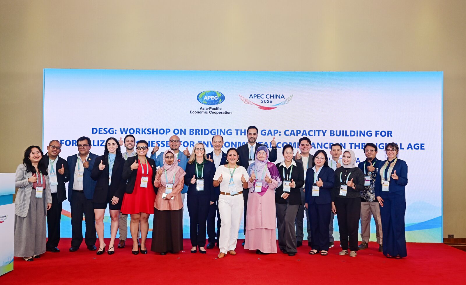Group photo of workshop participants on stage in Chengdu