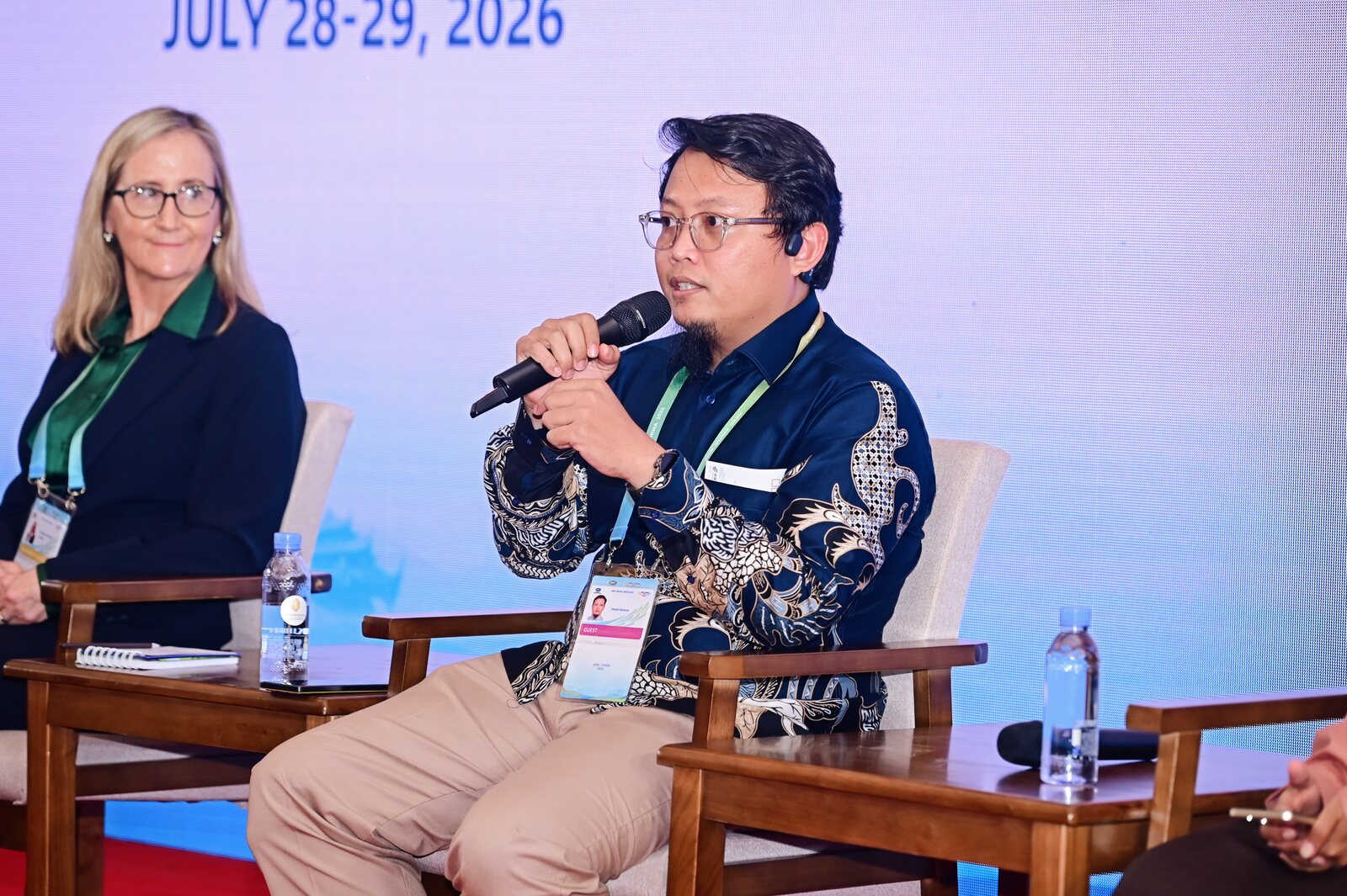 Hendri Karisma answering a question during the day one panel, seated beside Margaret Sexton